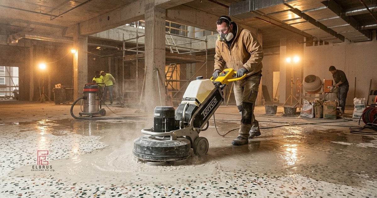 Terrazzo flooring installation process showing a worker grinding and polishing a freshly poured terrazzo floor